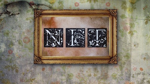Ornate gold frame with the letters 'NFT' in black and white against a vintage wall.